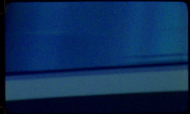 Abstract Super 8mm film leader with grainy textures, light leaks, and flashes of color, creating a vintage, damaged look