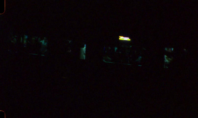 Vintage Super 8 film captures a passenger train traveling through the darkness of night