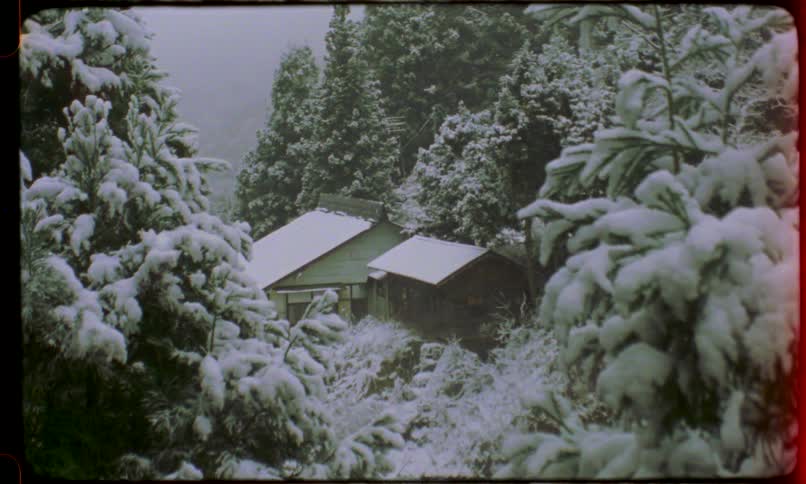Vintage film captures a quiet, traditional Japanese house nestled in a snowy mountain forest