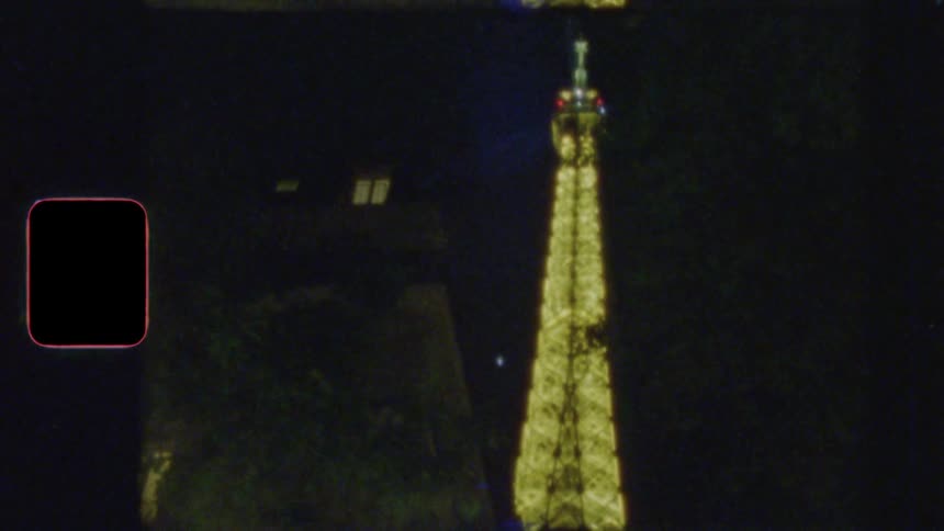 A vertical, vintage film perspective zooms out from the illuminated Eiffel Tower to the bustling streets of Paris at night
