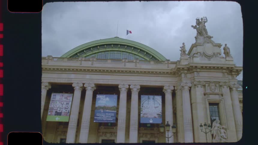 Vintage 16mm film captures the ornate architecture of the Grand Palais in Paris on an overcast day