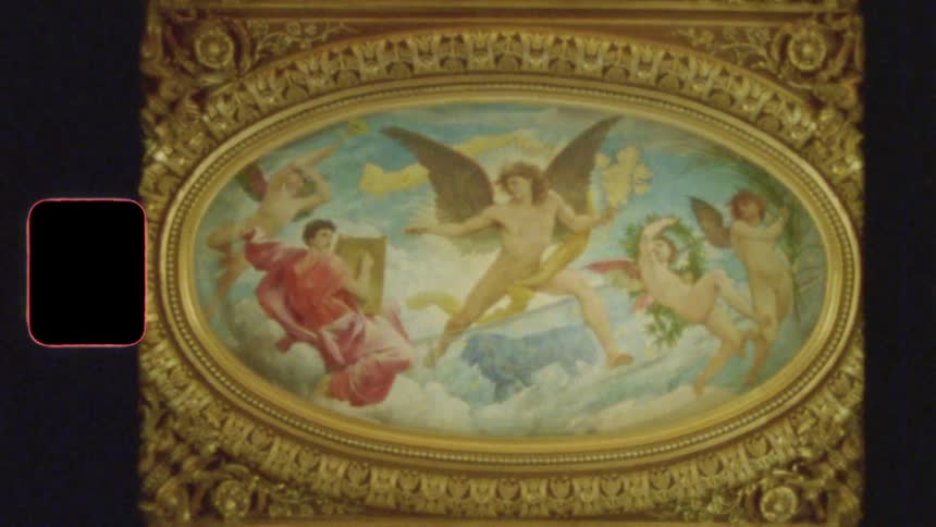 A vintage 8mm film shot of a classical painting of angels and mythological figures on an ornate, gilded ceiling
