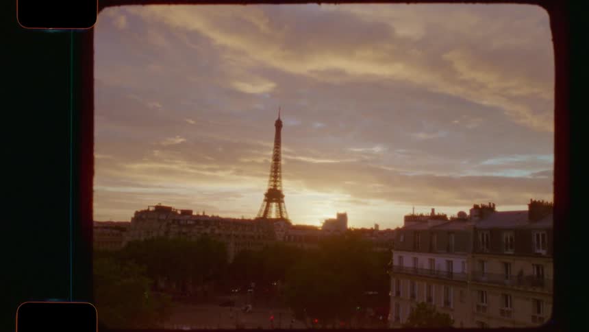 A vintage 16mm film look of the iconic Eiffel Tower and the Paris cityscape during a beautiful golden sunset