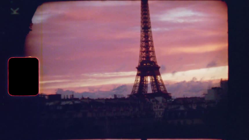 Vintage 8mm footage zooms out from the iconic Eiffel Tower against a breathtaking purple sunset over the Paris skyline
