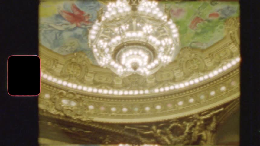 Vintage 8mm footage reveals the stunning Marc Chagall ceiling and grand crystal chandelier of the historic Palais Garnier opera house in Paris