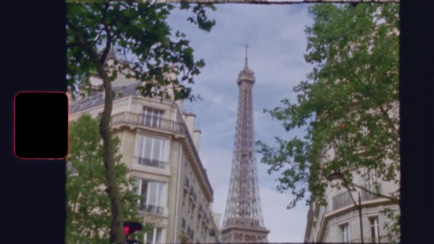 Vintage Super 8 film style shot tilting up from a classic Parisian street to reveal the iconic Eiffel Tower