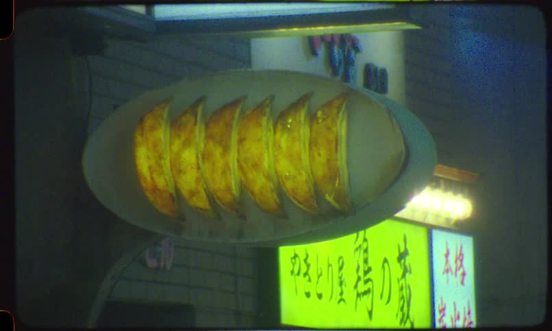 Vintage Super 8mm film footage of a glowing gyoza dumpling neon sign on a city street in Japan at night