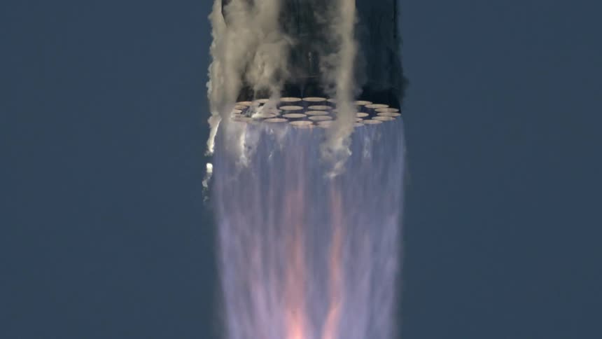 Slow motion CGI of a powerful rocket booster engine firing with intense flames and billowing smoke