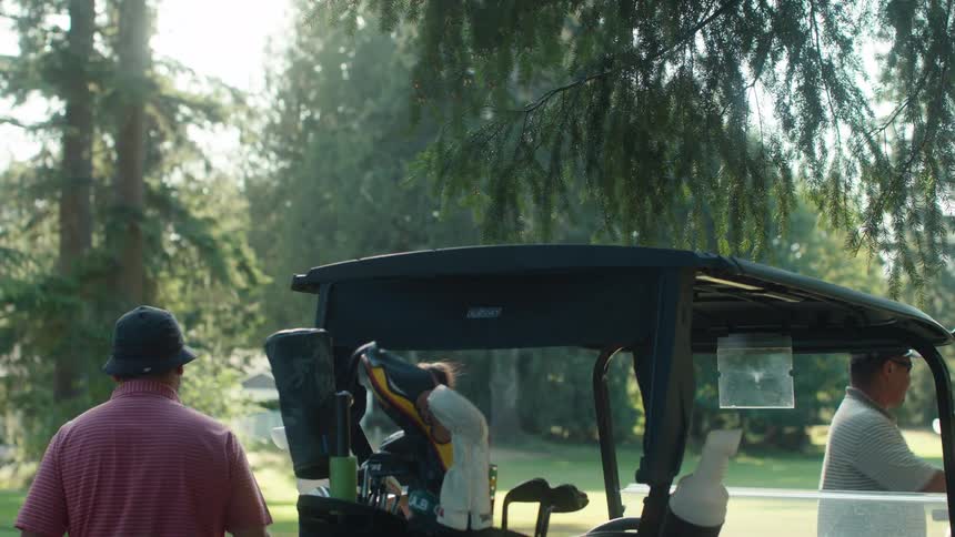 Friends gather around a golf cart, select their clubs, and head out to play a round of golf on a sunny day