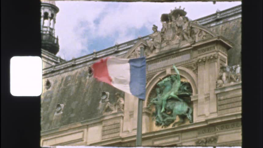 A vintage 8mm film captures the French flag waving in slow motion in front of an ornate Parisian building