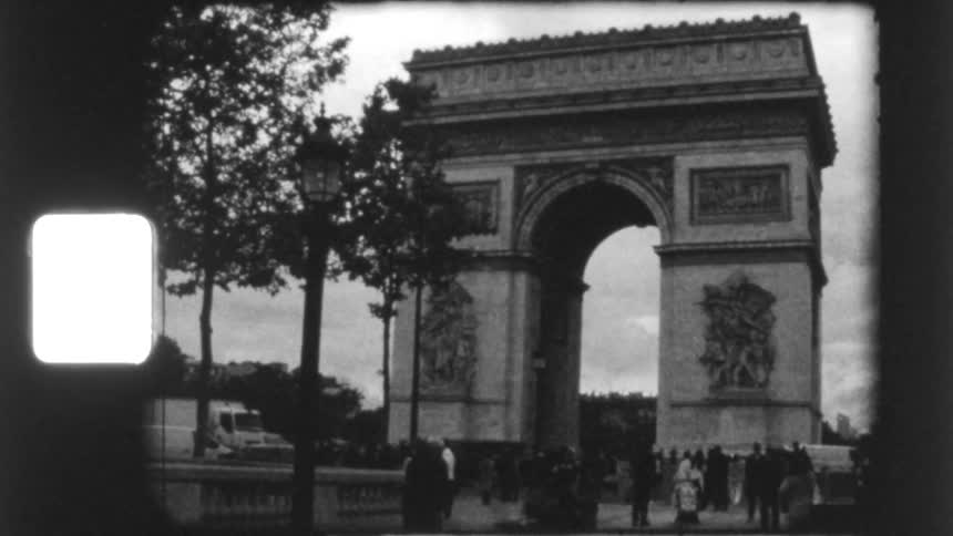 Archival black and white film captures street-level views of the iconic Arc de Triomphe in Paris