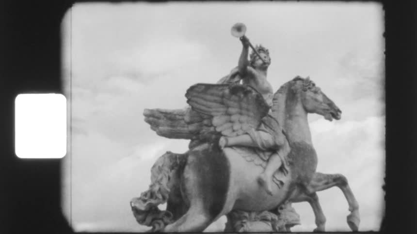 A grainy, black and white vintage film shot slowly zooms in on the majestic 'Fame on a winged horse' statue in Paris