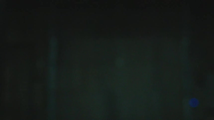Close-up of green glass shards raining down in slow motion