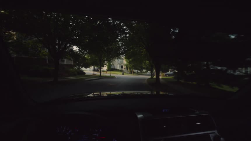 Driving through a peaceful suburban neighborhood, transitioning from deep tree shadows into the bright morning sun