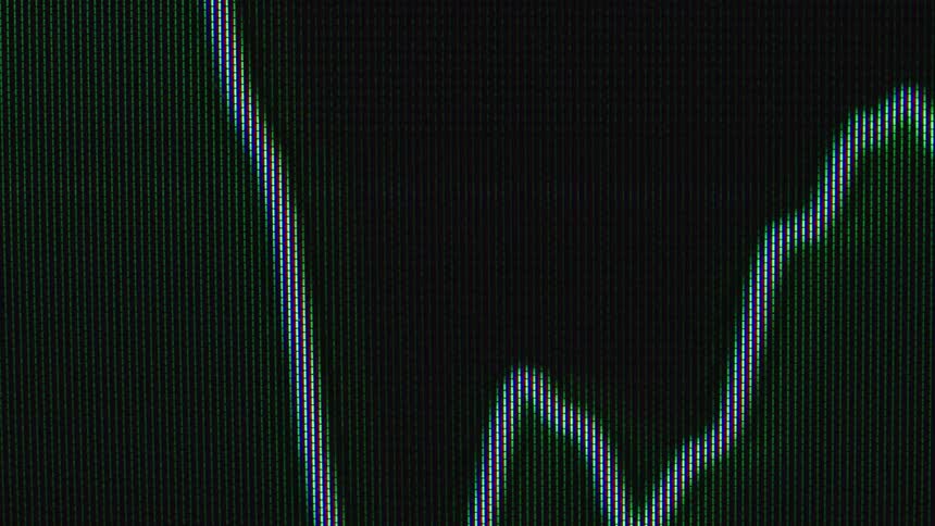 Extreme close-up of a digital display showing a fluctuating data line changing between green and red against a dark background