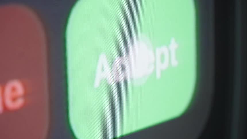 A macro close-up of a finger accepting an incoming call on a smartphone screen