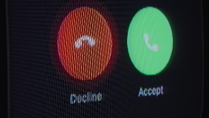 A close-up shot of a person declining an incoming phone call on a digital screen
