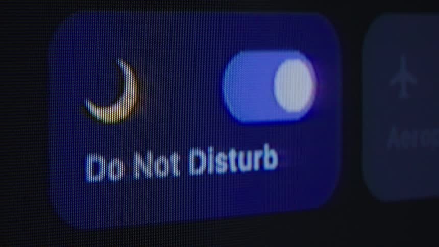 Macro close-up of smartphone control center switching on Do Not Disturb mode