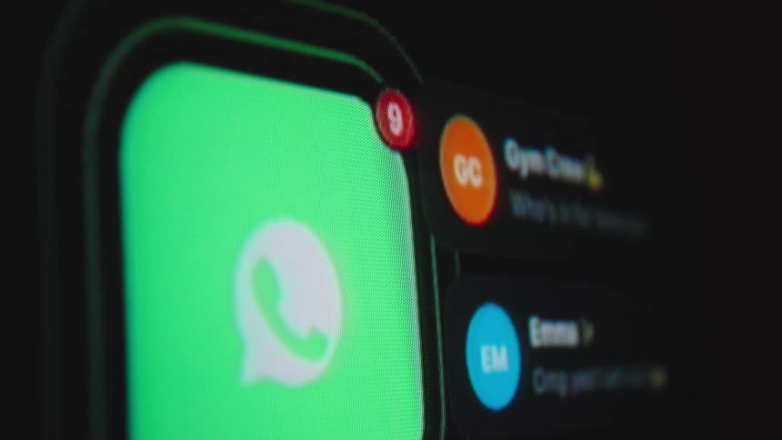 Close-up shot of a smartphone screen showing a messaging app icon as notifications pile up and the unread message counter rapidly increases
