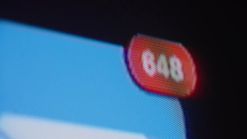 Macro shot of a red social media notification counter rapidly increasing to hundreds of new messages or alerts