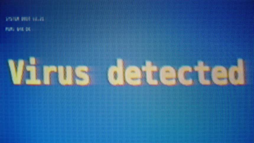 A retro computer screen types out a 'Virus detected' warning message followed by a system-crashing glitch
