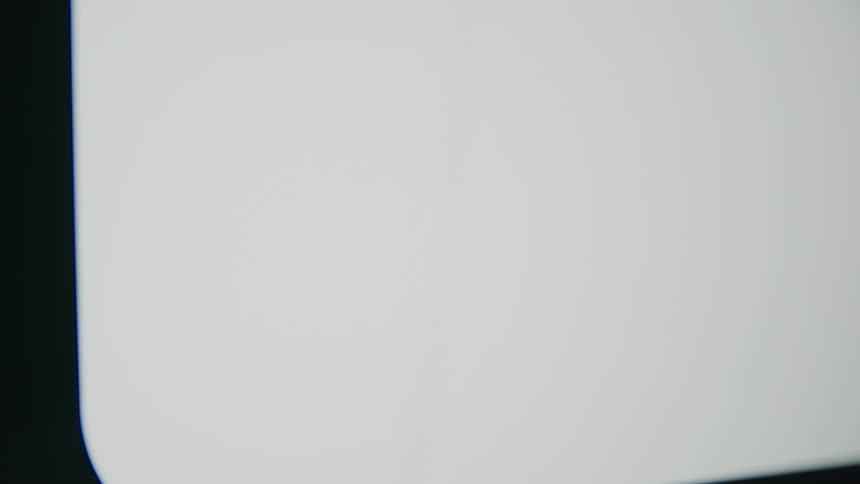 A close-up of a messaging app's 'typing' indicator, with three pulsing dots inside a speech bubble on a bright screen