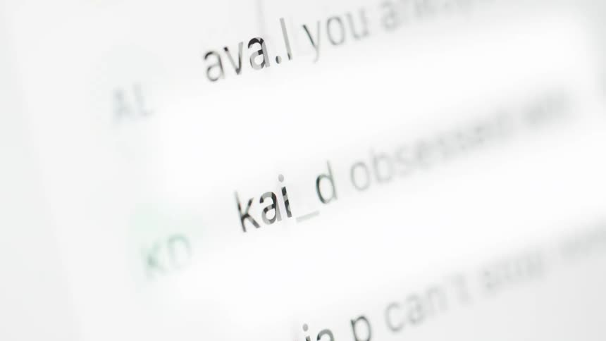 Close-up shot of social media comments endlessly scrolling on a bright digital screen