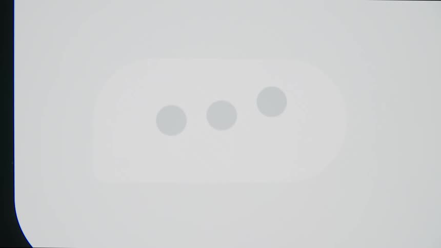 An animated text message typing bubble with three dots pulses on a white background