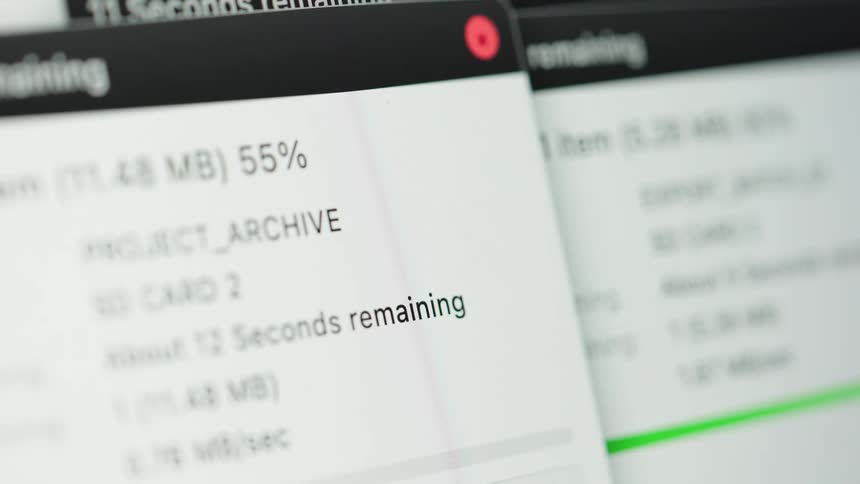 Montage of file copying dialog boxes on a computer screen, illustrating the process of data transfer and backup