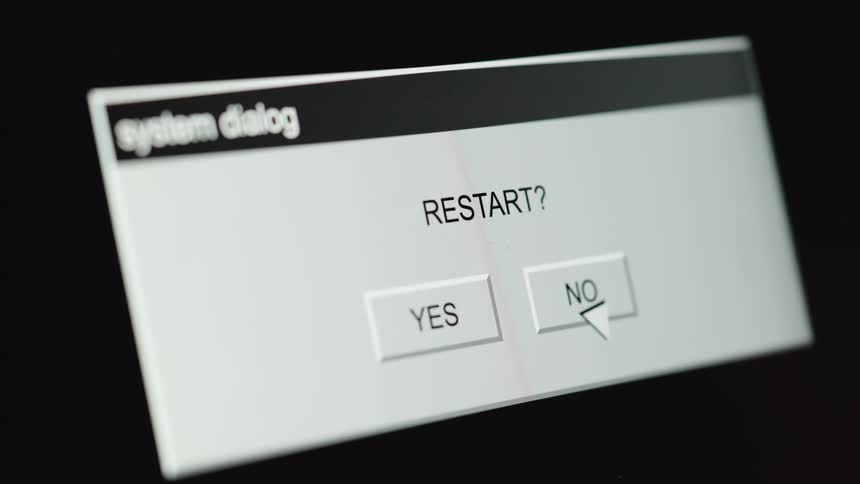 A computer user clicks 'YES' on a system restart dialog box, and the system begins restarting with a progress bar