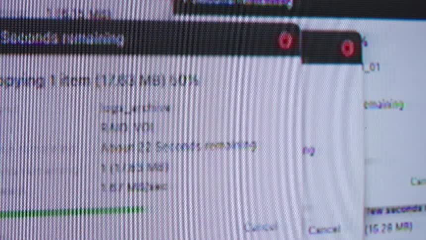 A close-up of multiple computer file transfer windows showing data copying with progress bars and remaining time