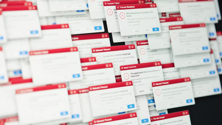 A computer screen becomes overwhelmed with cascading system error messages and critical failure alerts