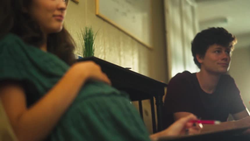 A young pregnant woman and her partner listen seriously during a consultation meeting about their future