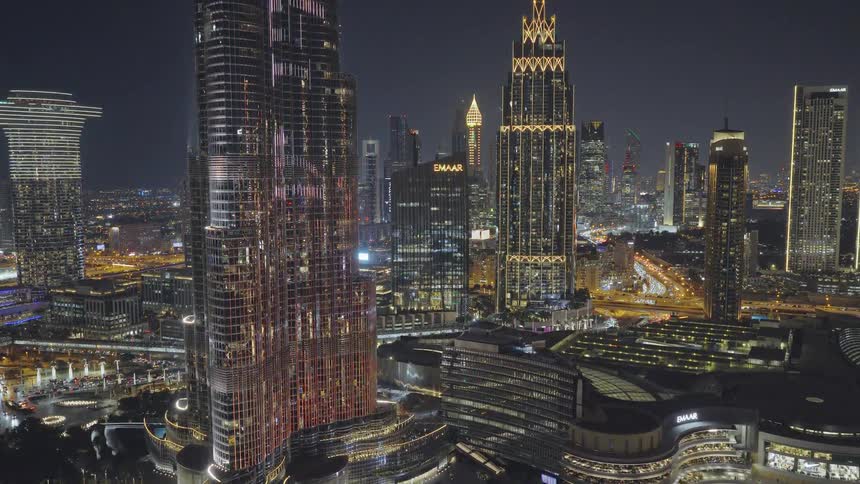 A stunning nighttime timelapse of the illuminated Dubai skyline, featuring the Burj Khalifa and bustling city traffic below