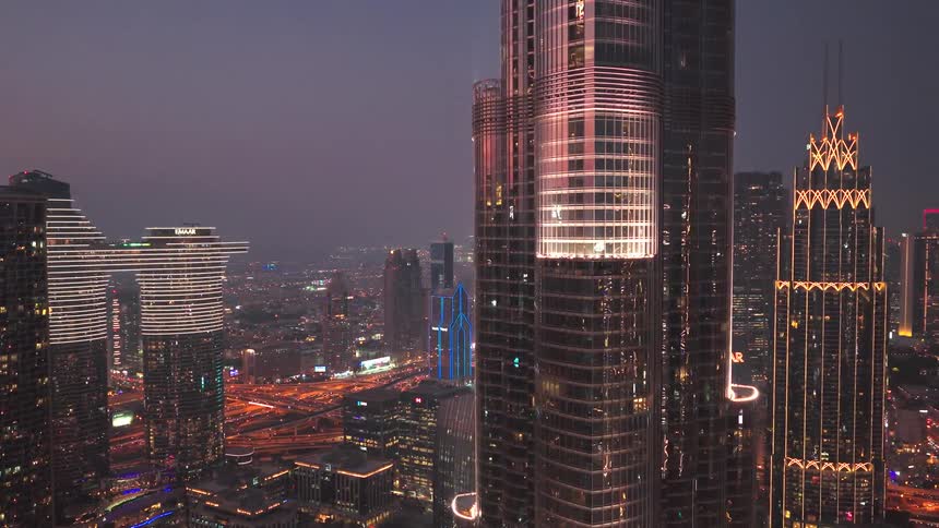 Stunning aerial shot revealing the futuristic Dubai skyline with the Burj Khalifa glowing at night
