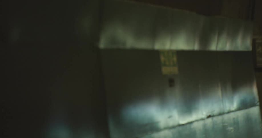 Point-of-view shot of driving through a dark and blurry underground tunnel