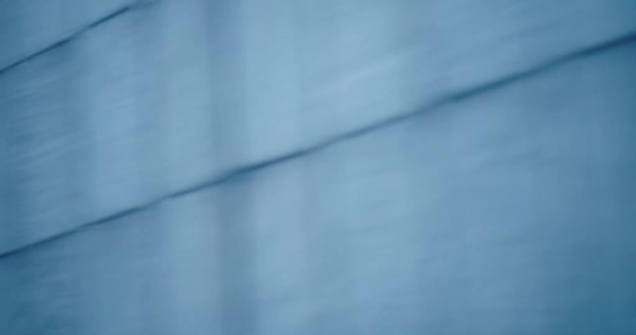 A fast-moving blue textured wall creates an abstract motion blur background in a seamless loop