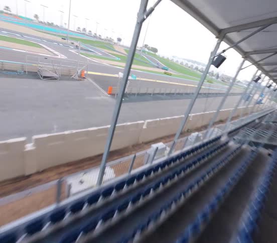 An FPV drone speeds through the empty grandstands before soaring over the vast Yas Marina Circuit racetrack in Abu Dhabi