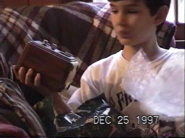 A young boy is surprised to receive a retro clock radio for Christmas in this 1997 home video