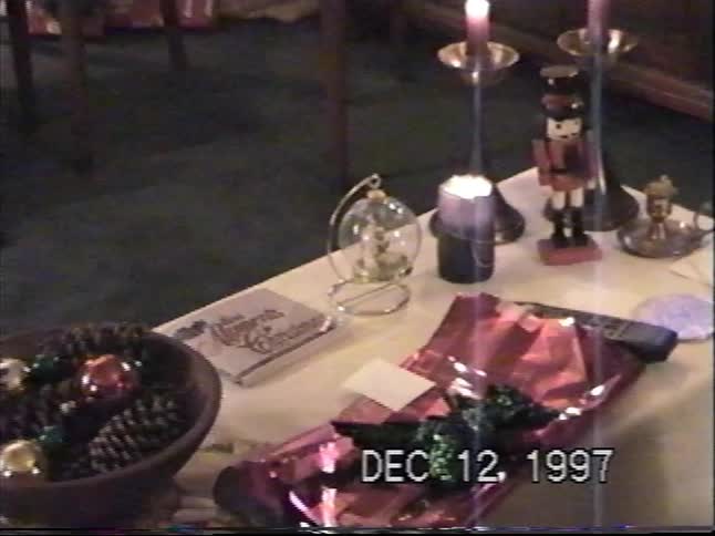 A nostalgic VHS recording from December 1997 shows a close-up of a beautifully decorated Christmas table
