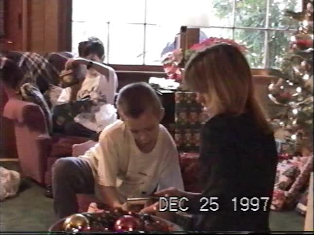 Vintage home video from 1997 shows children opening presents on Christmas morning