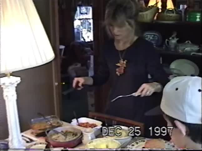 Vintage home video from 1997 shows a family serving a festive Christmas dinner with all the trimmings