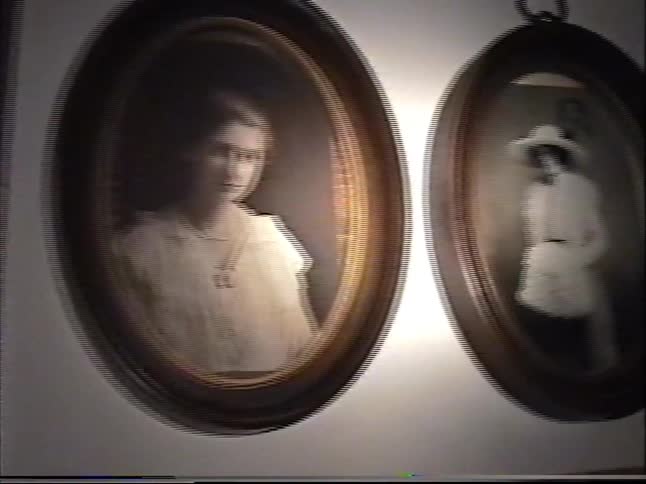 A sentimental journey through family history documented in vintage black and white photographs hanging on a wall