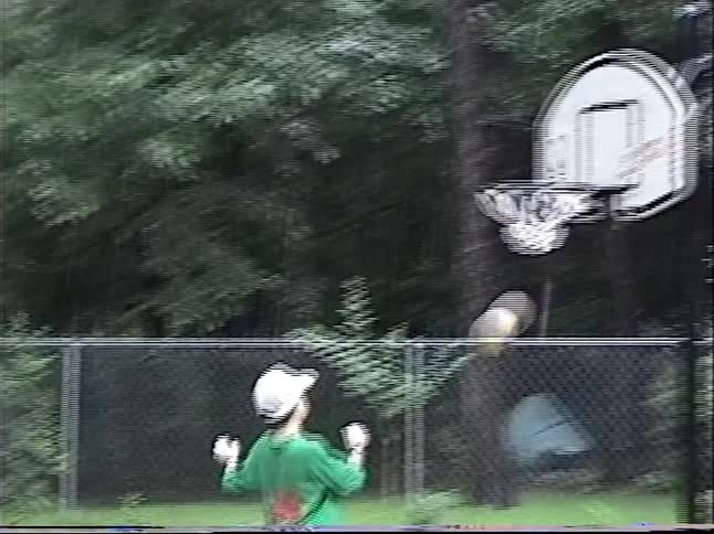 A nostalgic home video captures the pure joy of kids playing basketball and having a water gun fight in the pouring rain