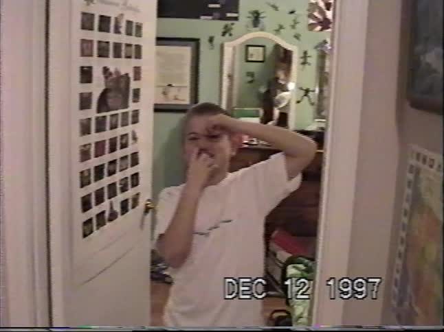 Kids are captured being silly in a vintage 1997 home video, with one boy making a funny face and another playing video games