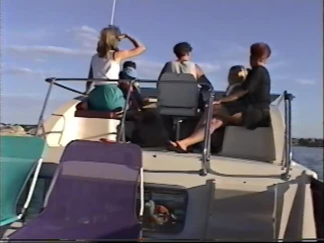 Vintage footage captures women and children relaxing and having fun while boating on a sunny day