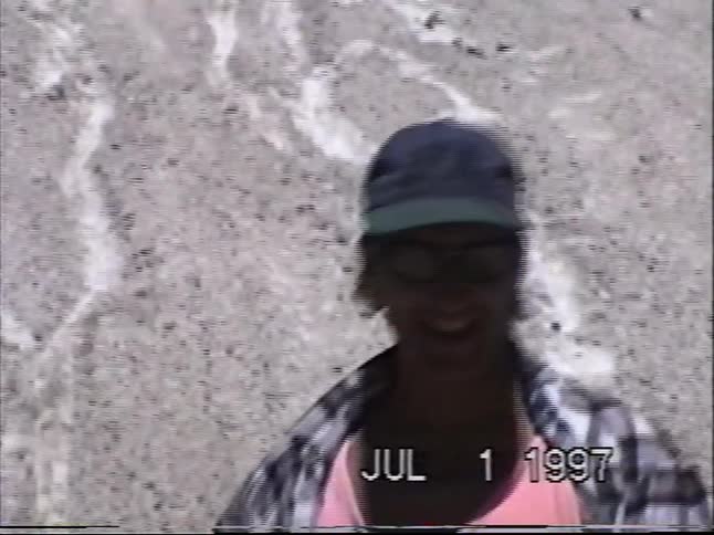 Vintage VHS footage shows a group of kids having a summer snowball fight on a mountain in 1997