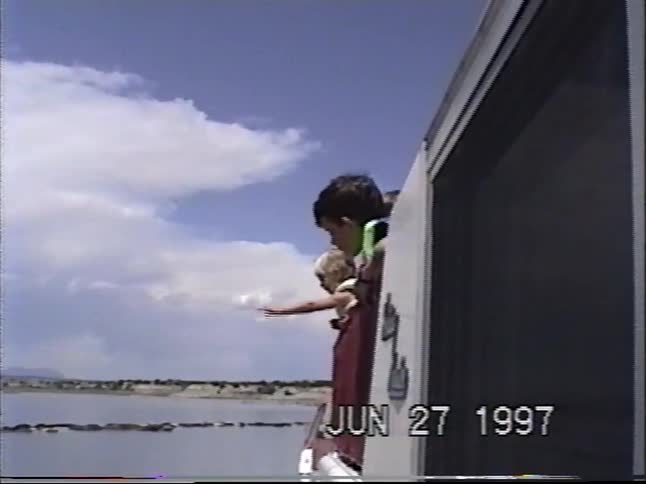 A nostalgic compilation of vintage home videos from 1997 showing boys playing in a hot tub and a family enjoying a day of boating on a lake