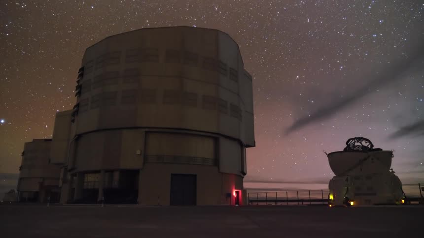A timelapse of the Very Large Telescope observatory in the Atacama Desert transitioning from a colorful sunset into a star-filled night