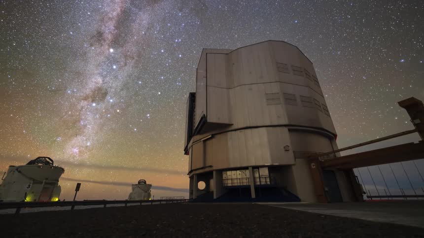 A breathtaking timelapse captures the Milky Way galaxy moving across the night sky over a rotating observatory, transitioning from a starry night to a brilliant sunrise